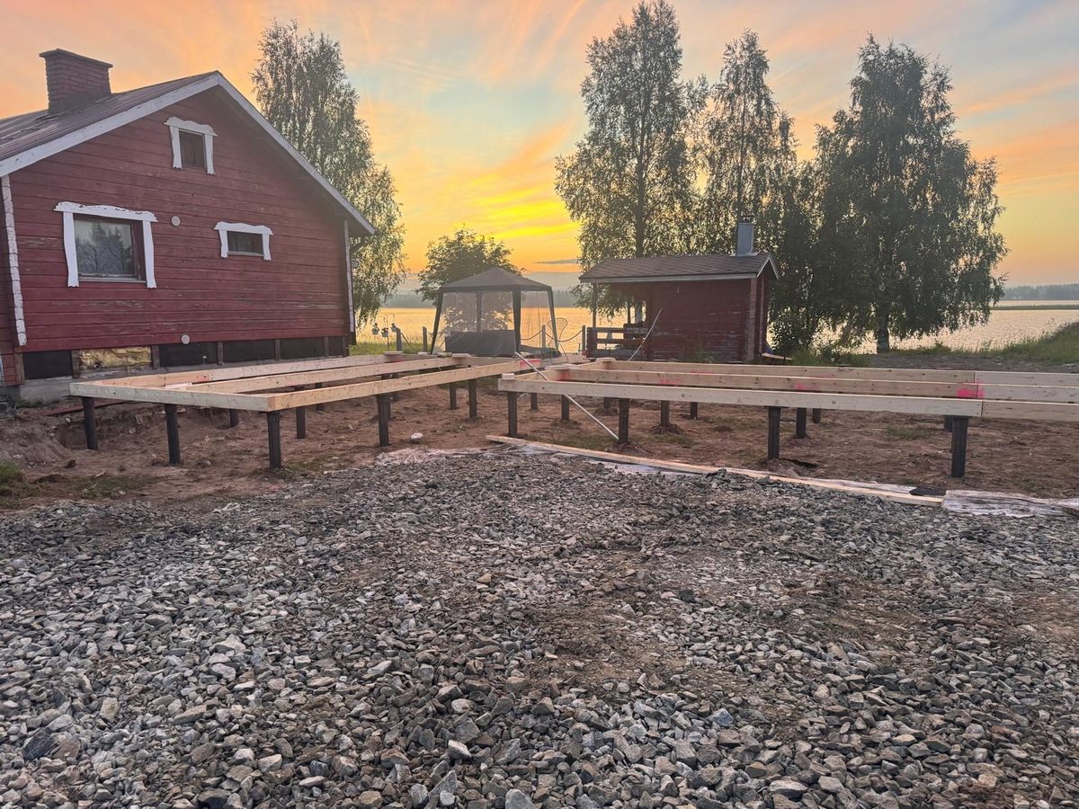 Steel beams on adjustable screw pile head plates at sunset, cabin foundation site