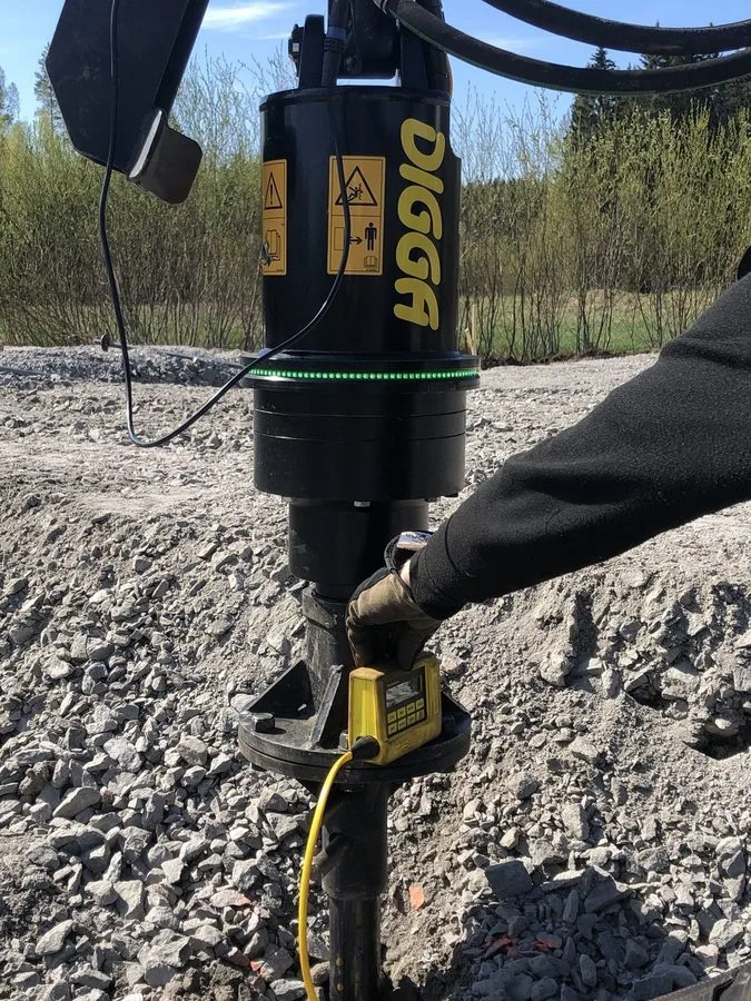 Close-up of Digga drive head installing screw piles for greenhouse foundations at Cassandras Tr&auml;dg&aring;rd, Porvoo